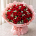 50 red roses bouquet with baby's breath and eucalyptus in pink Korean paper wrap
